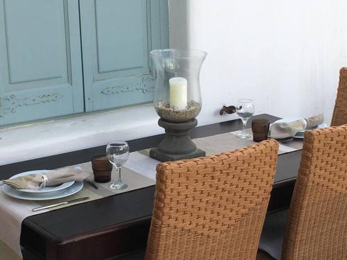 a dining room table with a candle and two chairs at Mykonos Summer House in Mikonos