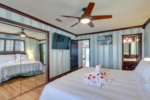 a bedroom with a bed and a ceiling fan at Waterfront Galveston Bay Retreat - 4 Mi to Beach! in Galveston