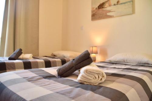 a room with two beds with towels on them at Pervolina countryside by the sea in Pervolia