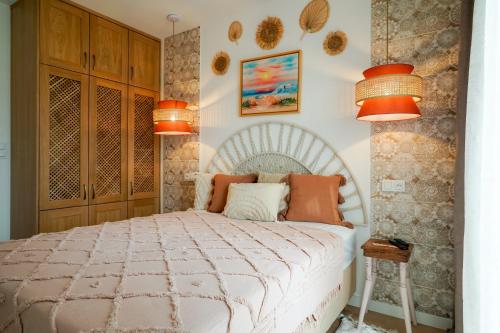 a bedroom with a white bed with orange lamps at Apartament Gdańsk Premium Porto in Gdańsk