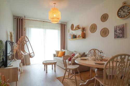 a living room with a table and a couch at Apartament Gdańsk Premium Porto in Gdańsk