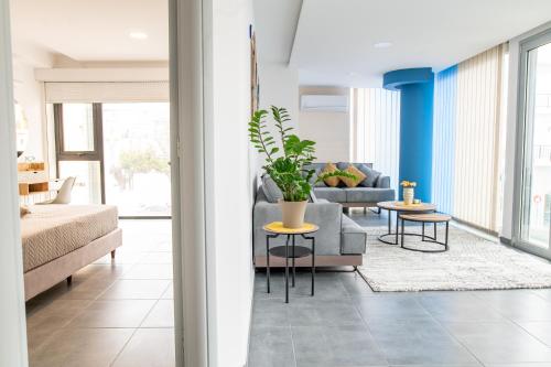 a living room with a couch and a table at Zoes Apartment Kos Town in Kos