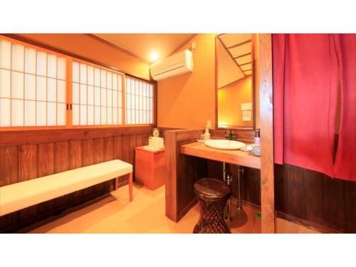 a bathroom with a sink and a bench in it at Saikatei Jidaiya - Vacation STAY 96456v in Kaminoyama