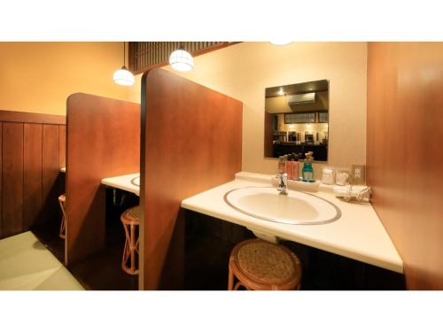 a bathroom with a sink and a mirror at Saikatei Jidaiya - Vacation STAY 96456v in Kaminoyama