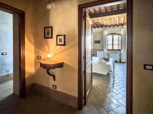 a hallway with a table and a room with a bed at Borgo Pian di Sala in San Gimignano
