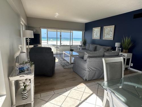 a living room with a couch and a table at Island House Beach Resort 3N in Siesta Key