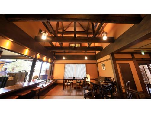 a dining room with tables and chairs in a building at Saikatei Jidaiya - Vacation STAY 96435v in Kaminoyama