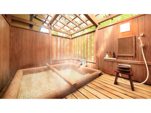 a bathroom with a bath tub in a house at Saikatei Jidaiya - Vacation STAY 96452v in Kaminoyama