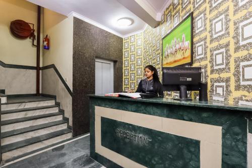 a woman standing at the counter of a restaurant at Collection O Ramji 7 Grand Near Tdi Mall in New Delhi