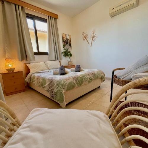 a bedroom with two beds and a window at Pervolina countryside by the sea in Pervolia