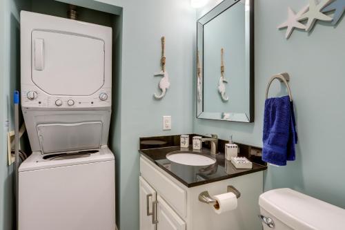 ein Badezimmer mit einem Waschbecken, einer Waschmaschine und einem Trockner in der Unterkunft Waterfront Middle Bass Condo with Lake Erie Views! in Put-in-Bay