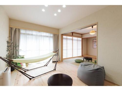 a hammock in a room with a living room at KONOHANA NO IORI - Vacation STAY 15340v in Mimasaka