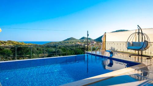 a swimming pool with a view of the ocean at VİLLA TANYERİ in Kas