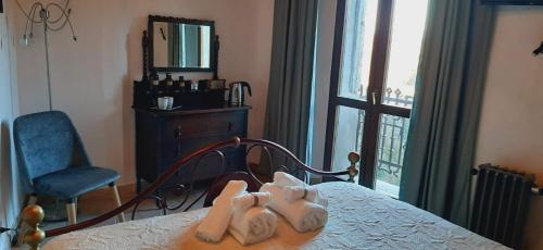 a bedroom with a bed and a chair and a window at Casa Lale in Corchiano