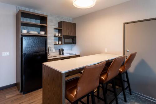 a kitchen with a large island with leather chairs at Running Aces Hotel & Casino, Trademark Collection by Wyndham in Forest Lake