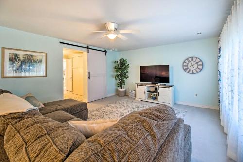 a living room with a couch and a flat screen tv at Refreshing Colonial Beach Vacation Rental! in Colonial Beach