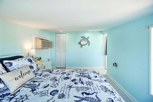 a bedroom with a bed with a blue wall at Refreshing Colonial Beach Vacation Rental! in Colonial Beach