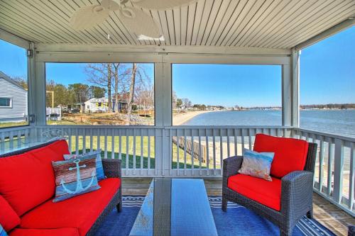 a screened in porch with two chairs and a table at Refreshing Colonial Beach Vacation Rental! in Colonial Beach