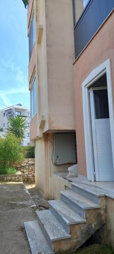 a building with steps leading up to a door at Chrisa apartament in Metogjashta