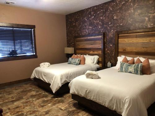 a hotel room with two beds and a window at Zion Cliff Lodge in Hildale