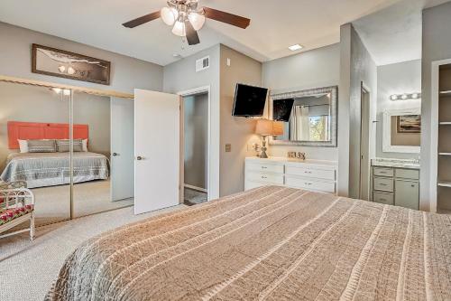 a bedroom with a large bed with a ceiling fan at Full Moon Harbor in Horseshoe Bay