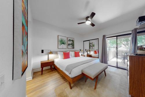 a bedroom with a bed and a ceiling fan at Oasis Harmony Permit# 5412 in Palm Springs