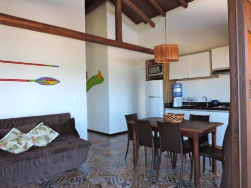 a kitchen and dining room with a table and chairs at Pousada Pedra da Gaivota in Bombinhas