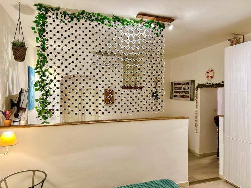 a kitchen with a window with ivy on the wall at Luxury Sea House in Rodi Garganico