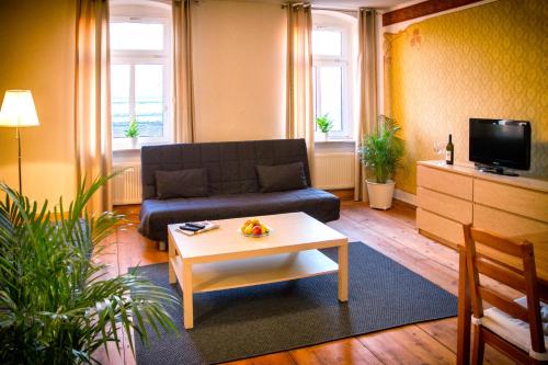 a living room with a couch and a coffee table at Aparthotel Mitte in Dresden