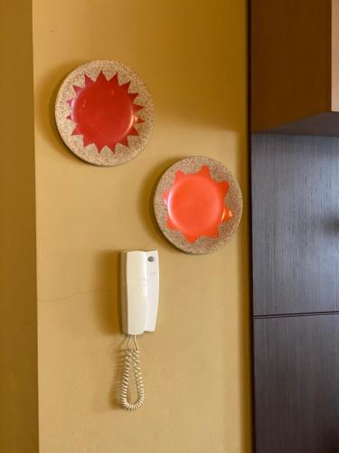 a phone on a wall next to a cupcake at Sunshine Place in Elbasan