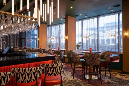 a restaurant with tables and chairs and chandeliers at Malmaison Liverpool in Liverpool