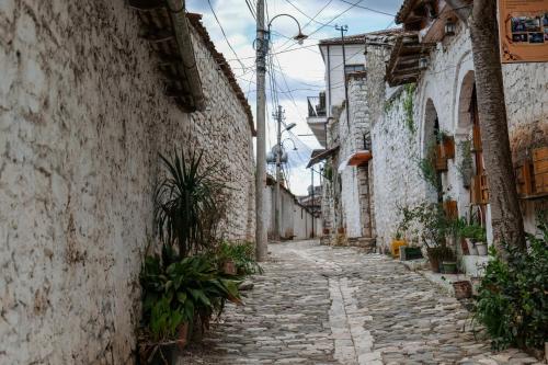 an alley in an old town with stone buildings at Hotel Gorica - UNESCO quarter in Berat
