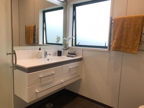 a bathroom with a sink and a window at Ridley Manor in Ohakune