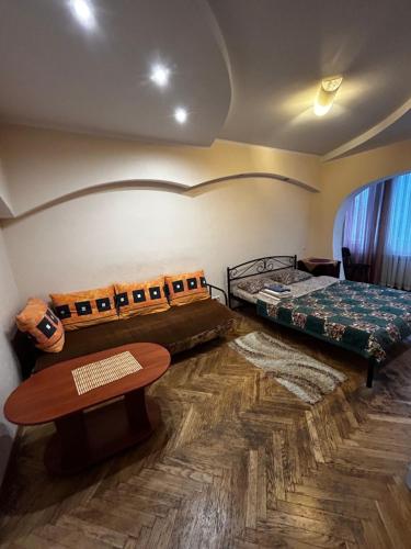 a room with two beds and a table at Apartment near train station and close to city center in Kyiv