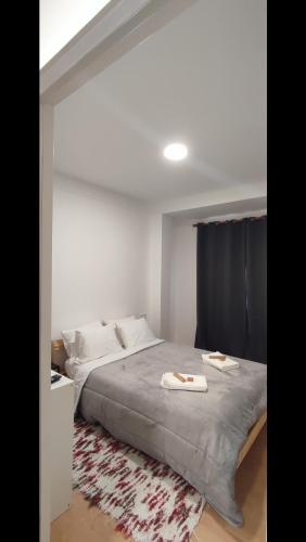 a bedroom with a bed with two towels on it at Habtiar Guest House in Braga