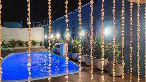 una piscina en medio de un patio por la noche en Wind Village Chalés, en São Miguel do Gostoso