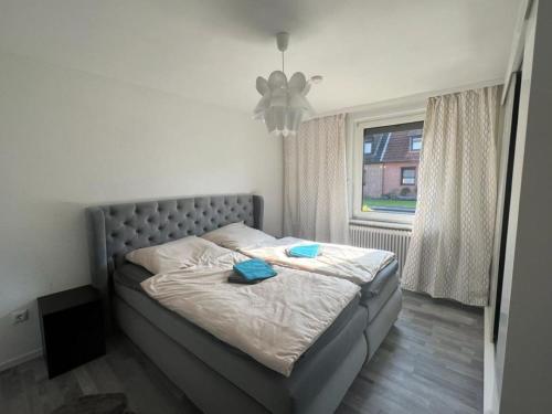 a bedroom with a bed with blue towels on it at Cozy villa with garden, balcony and parking area in Düsseldorf in Düsseldorf