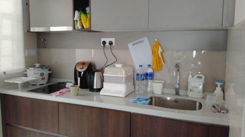a kitchen with a sink and a counter top with a sink at Cozy Southville Bangi Free parking Wifi Netflix in Bangi