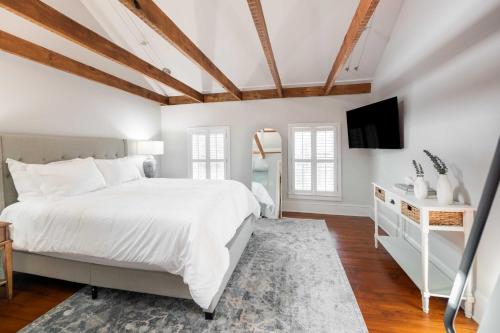 a bedroom with a white bed and a tv at Charming Brooke House with Patio - In Town! in Lambertville