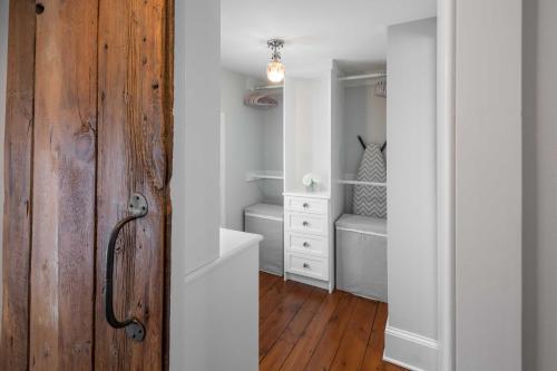 a room with a closet with a wooden door at Charming Brooke House with Patio - In Town! in Lambertville