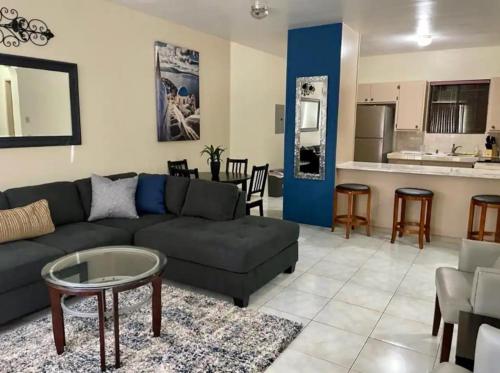a living room with a couch and a table at Beautiful Condos walking distance to a private beach! in Tamuning