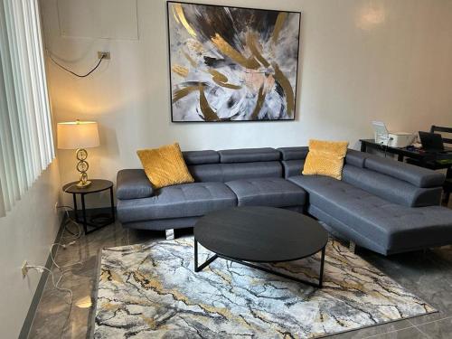 a living room with a couch and a table at Beautiful Condos walking distance to a private beach! in Tamuning