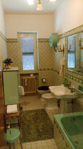 a bathroom with a sink and a toilet and a mirror at B&B Vittoria Colonna in Marino