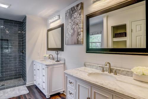a bathroom with a sink and a mirror and a shower at Beckenham 209 in Hilton Head Island