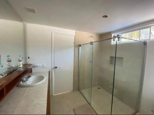 a bathroom with a glass shower and a sink at Marie Joseph Villa in San Andrés