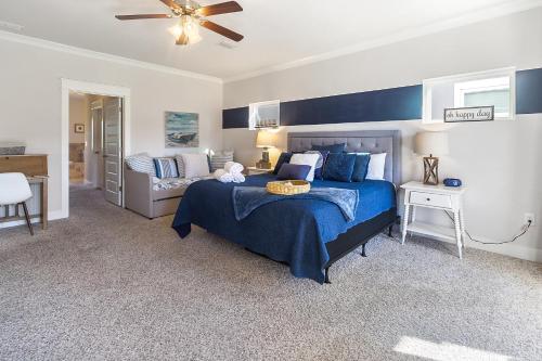 a bedroom with a bed with a blue bedspread at Arborgate Gate Away At 7971 Double Gate Dr By Pkrm in Pensacola