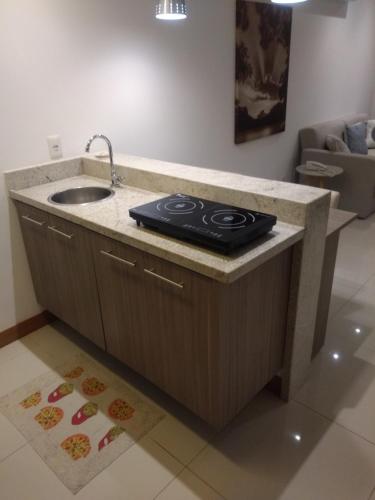 a kitchen with a sink and a counter top at Samba Rio - Farmasi Arena - Rio Centro - Parque Olimpico - Projac - Barra in Rio de Janeiro
