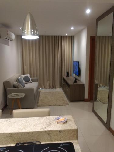 a living room with a couch and a television at Samba Rio - Farmasi Arena - Rio Centro - Parque Olimpico - Projac - Barra in Rio de Janeiro