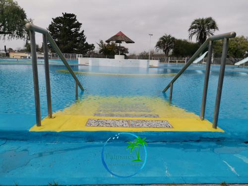 a ramp in the water at a swimming pool at Palmares Apart Termal in Termas de Guaviyu