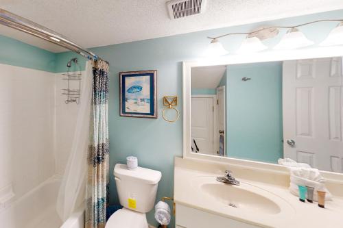 a bathroom with a sink and a toilet and a mirror at Sea Cabin 2D in Destin